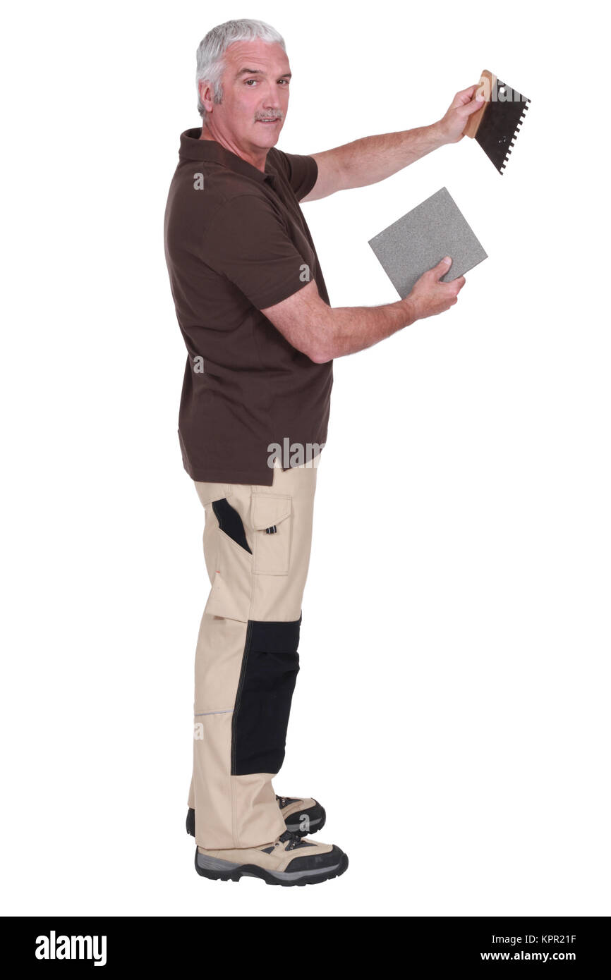 Man holding a tile and a spatula Stock Photo Alamy