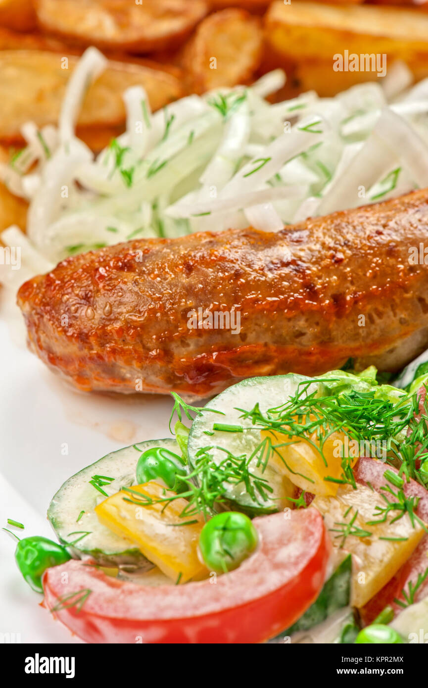 Roasted sausage with vegetables Stock Photo