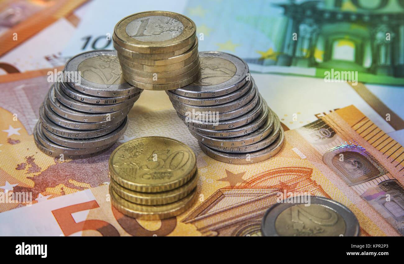Stacked one and two Euro coins with paper banknotes Stock Photo - Alamy
