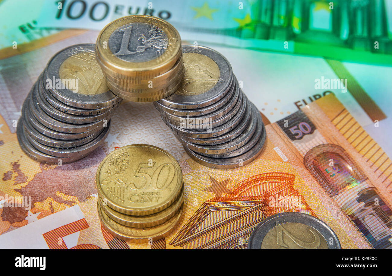 Stacked one and two Euro coins with paper banknotes Stock Photo - Alamy