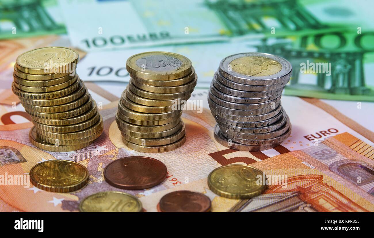 Stacked one and two Euro coins with paper banknotes Stock Photo - Alamy