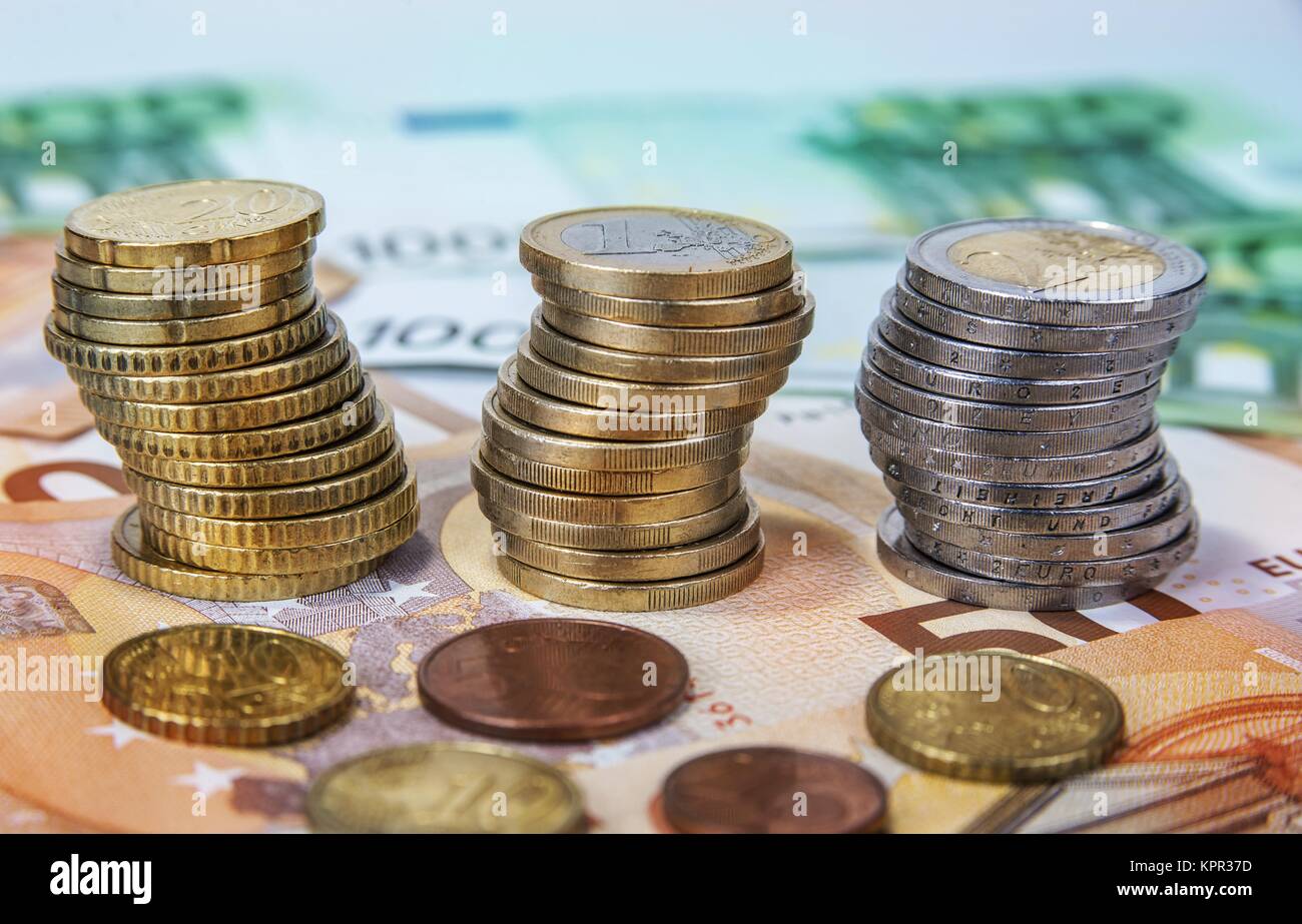 Stacked one and two Euro coins with paper banknotes Stock Photo - Alamy