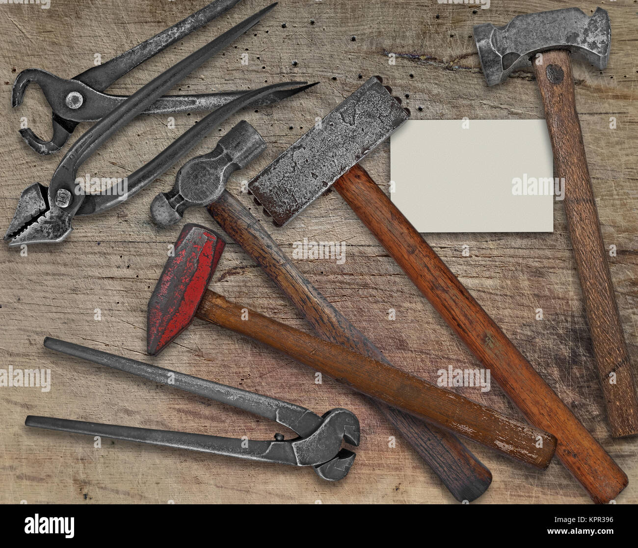 blacksmith tools and business card over bench Stock Photo