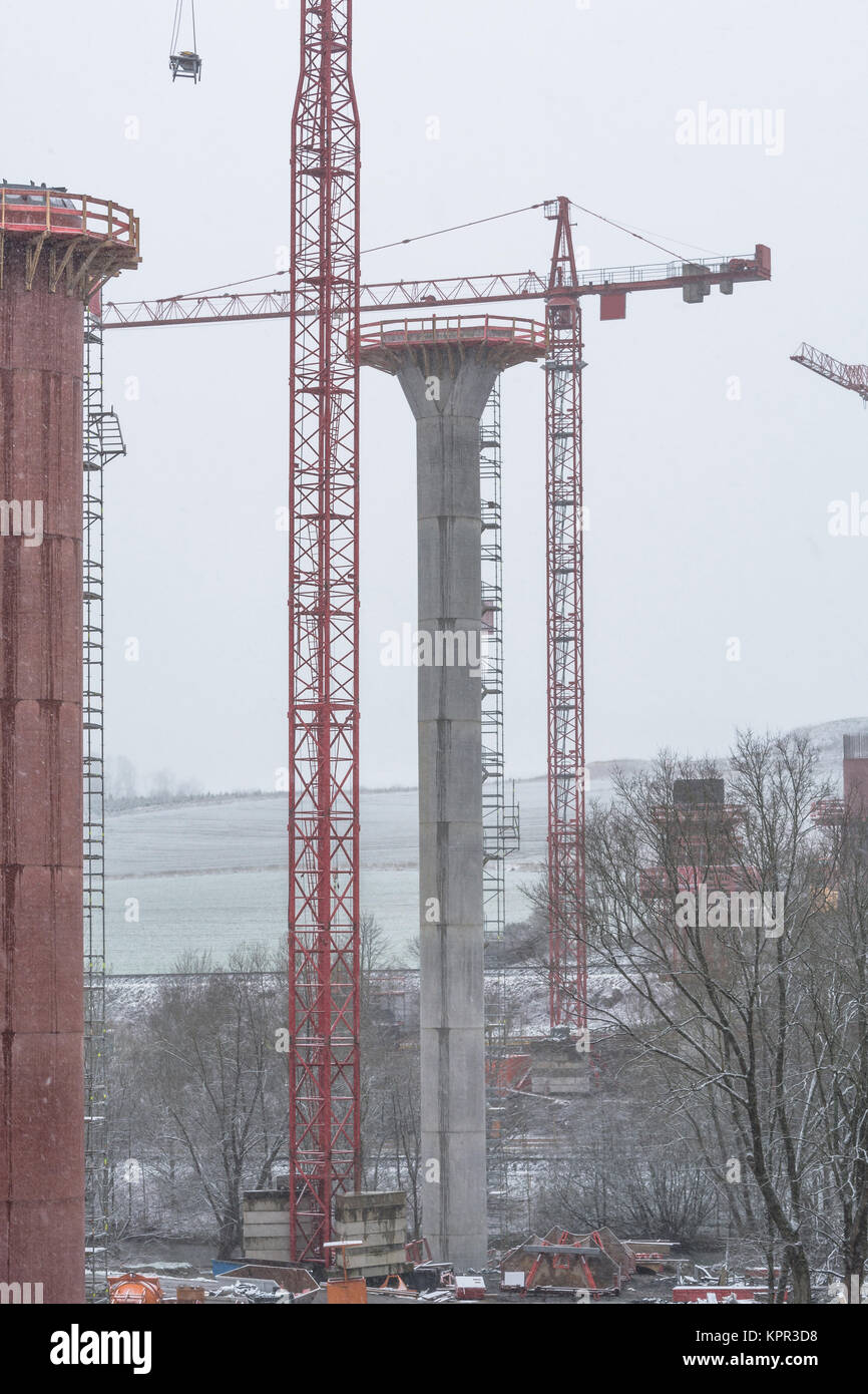 Bridge construction sites, bridge under construction seen in heavy snowfall from below. Stock Photo