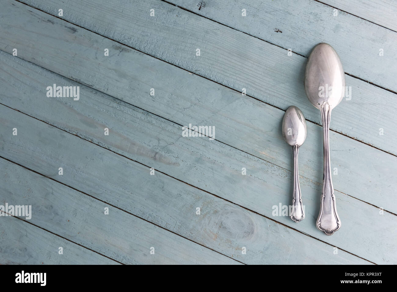 Food background with antique silver spoons Stock Photo