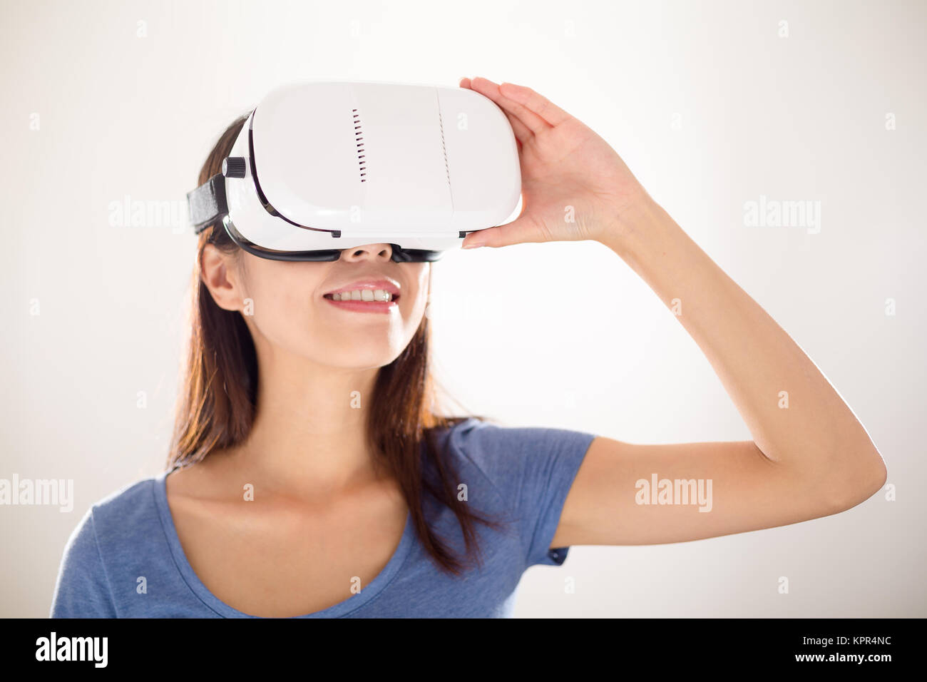 Asian woman using virtual reality device Stock Photo - Alamy