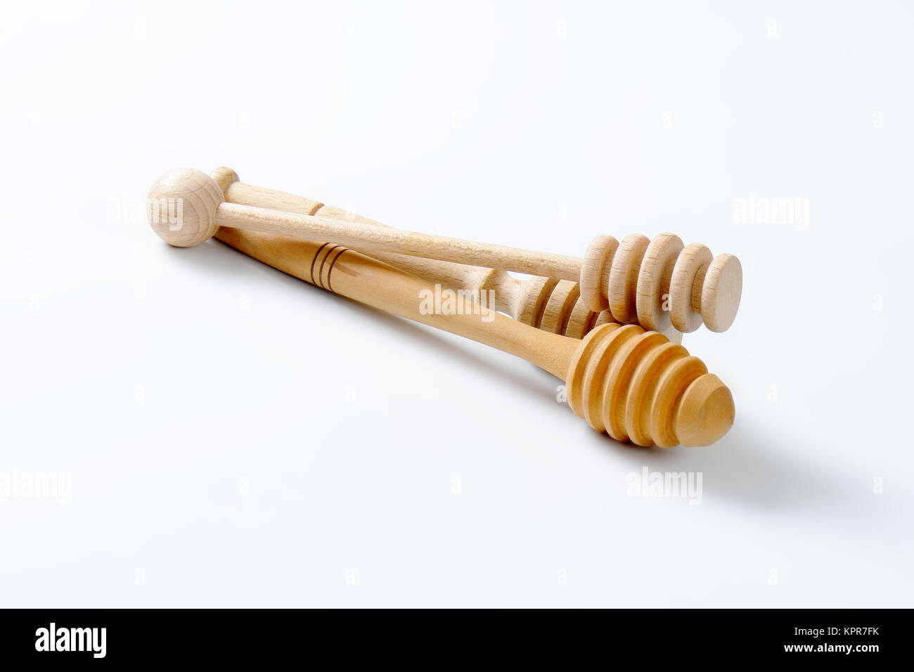 wooden honey dippers Stock Photo