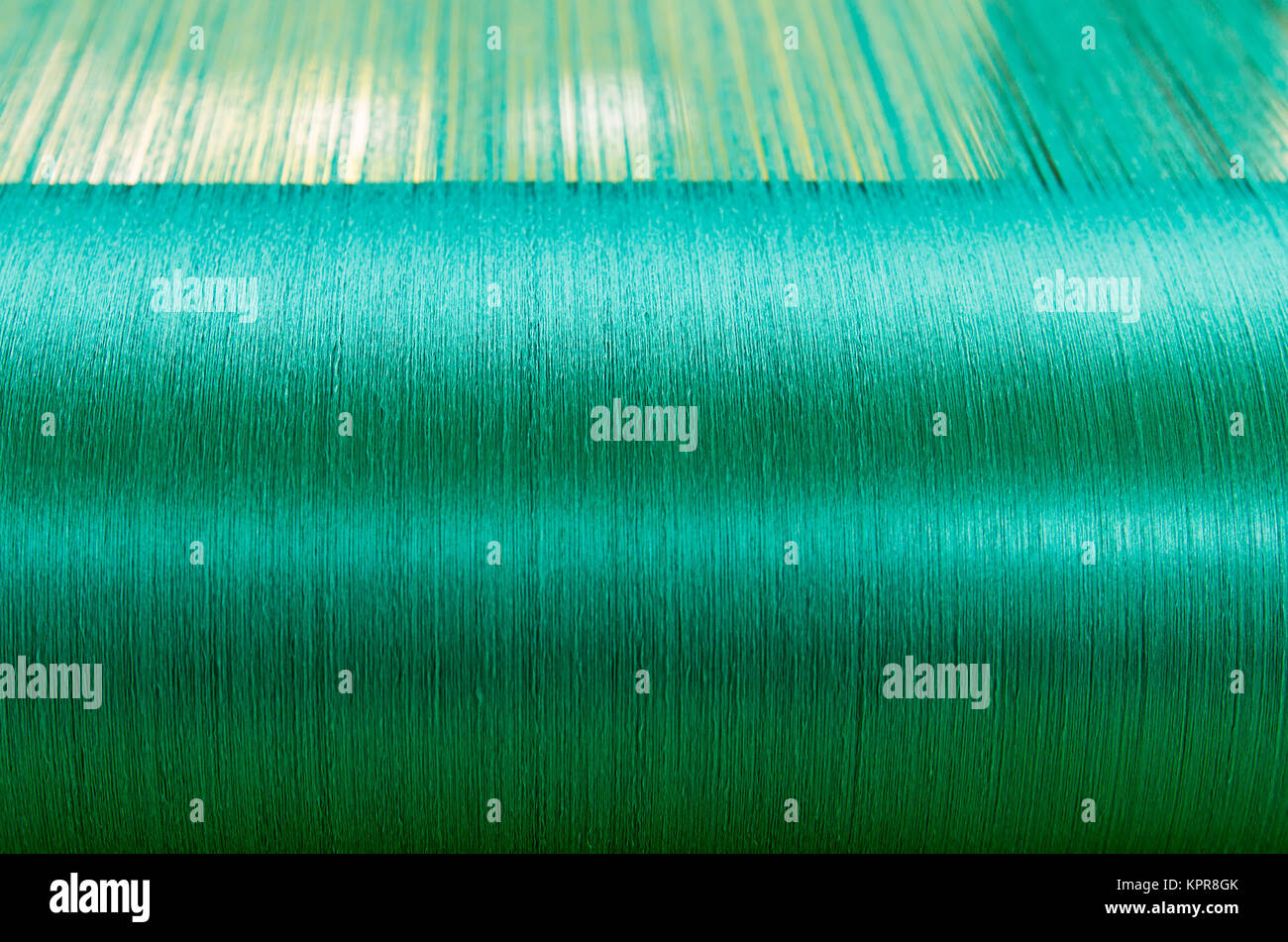 Green silk on a warping loom of a textile mill Stock Photo Alamy
