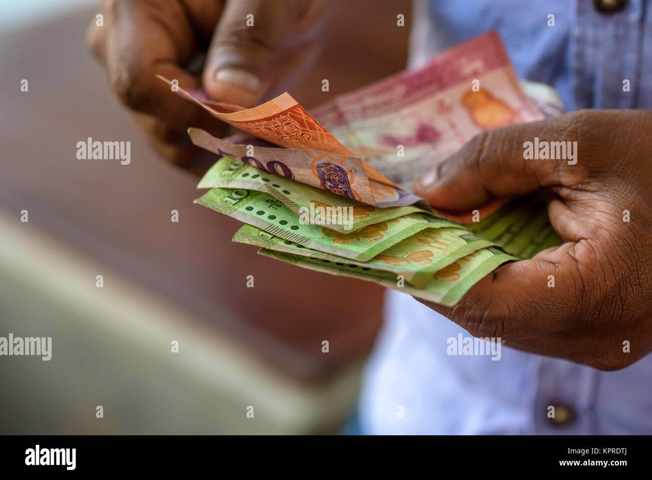 Hands counting srilankan rupies Stock Photo - Alamy
