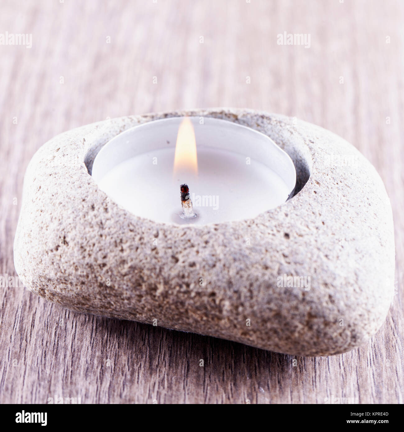 Candle in stone Stock Photo Alamy