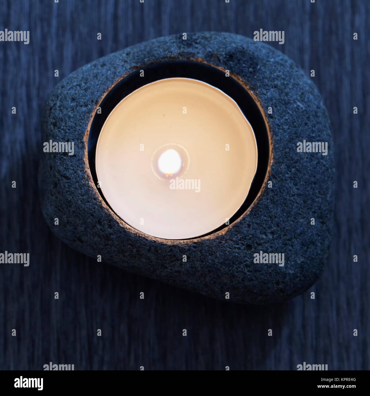 Candle in stone Stock Photo Alamy