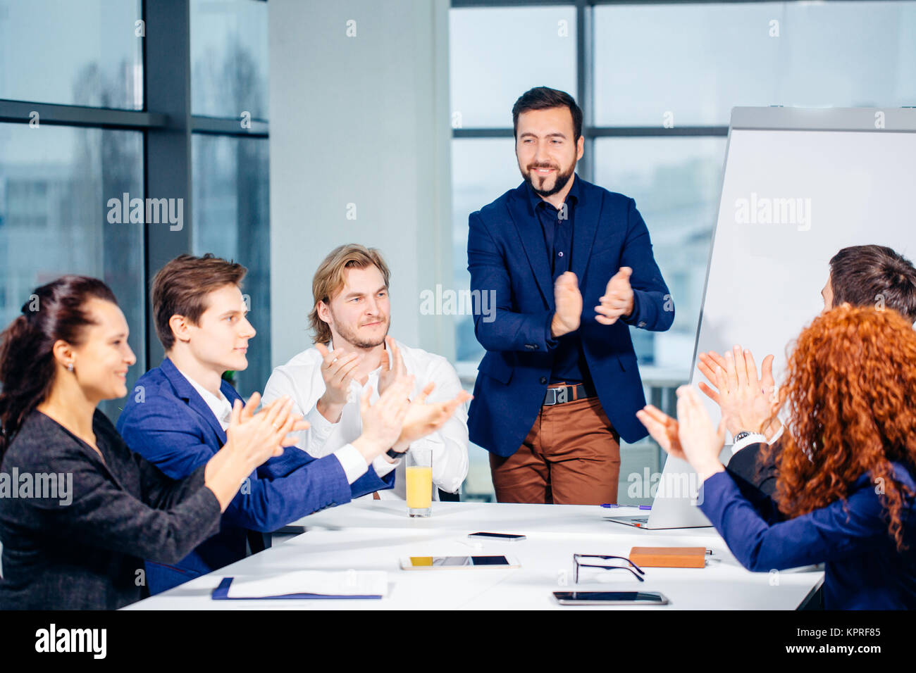 Startup team clapping hands of consent at group presentation on
