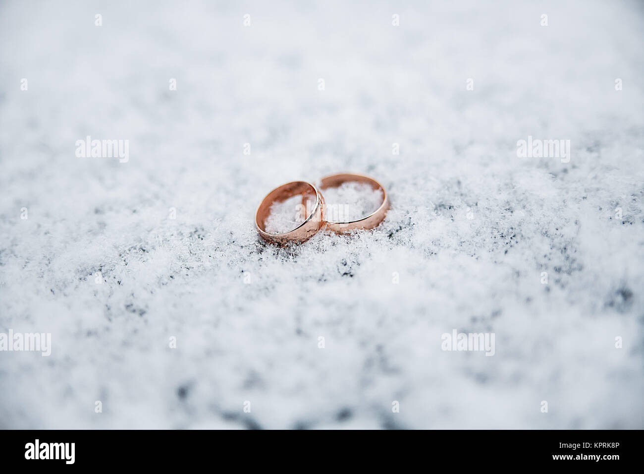 Beautiful Wedding rings on the snow Stock Photo - Alamy