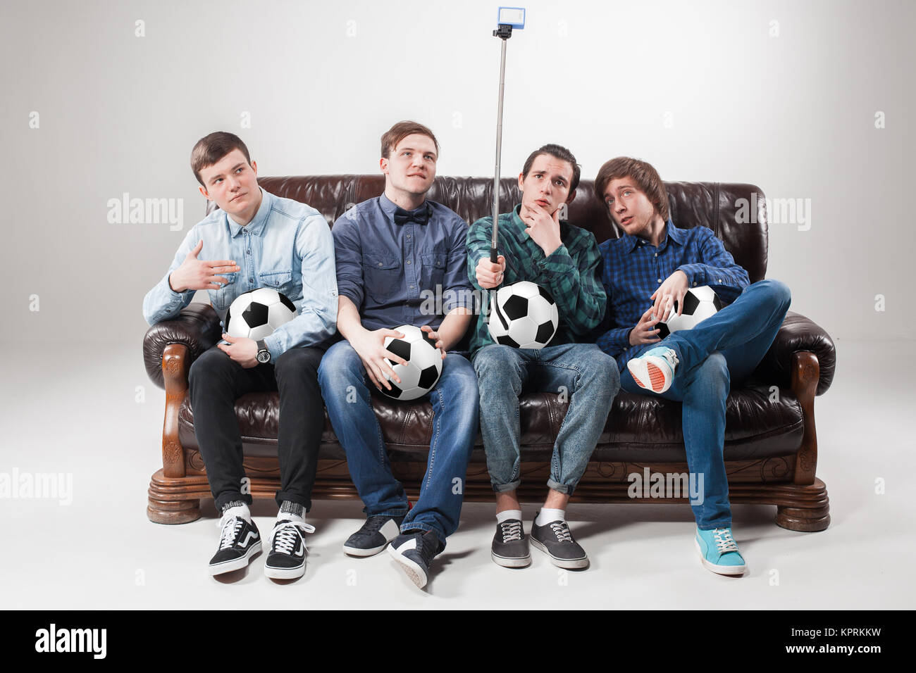 The four guys with balls on gray background Stock Photo