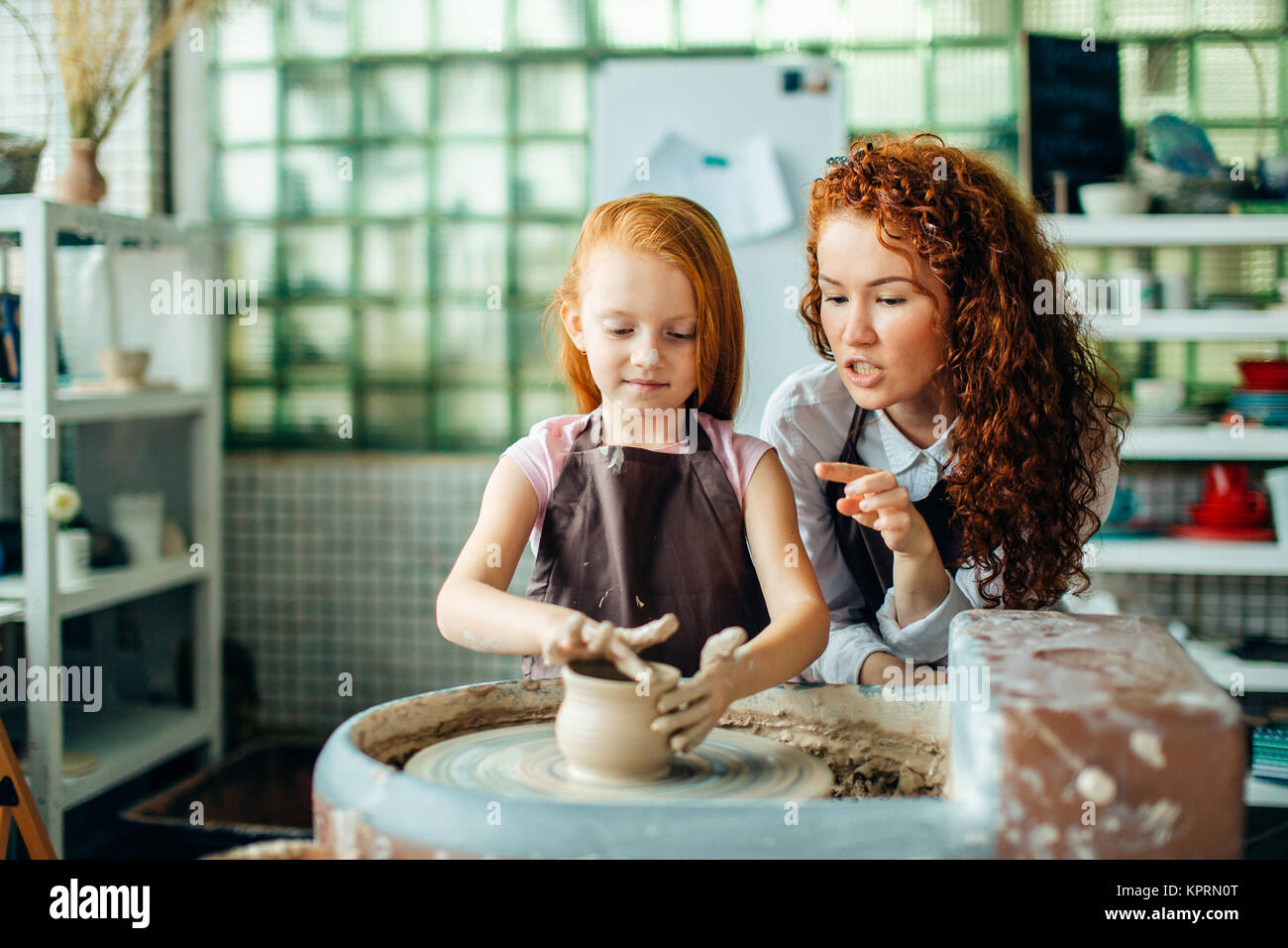 teacher and student make pitcher of pottery wheel Stock Photo Alamy