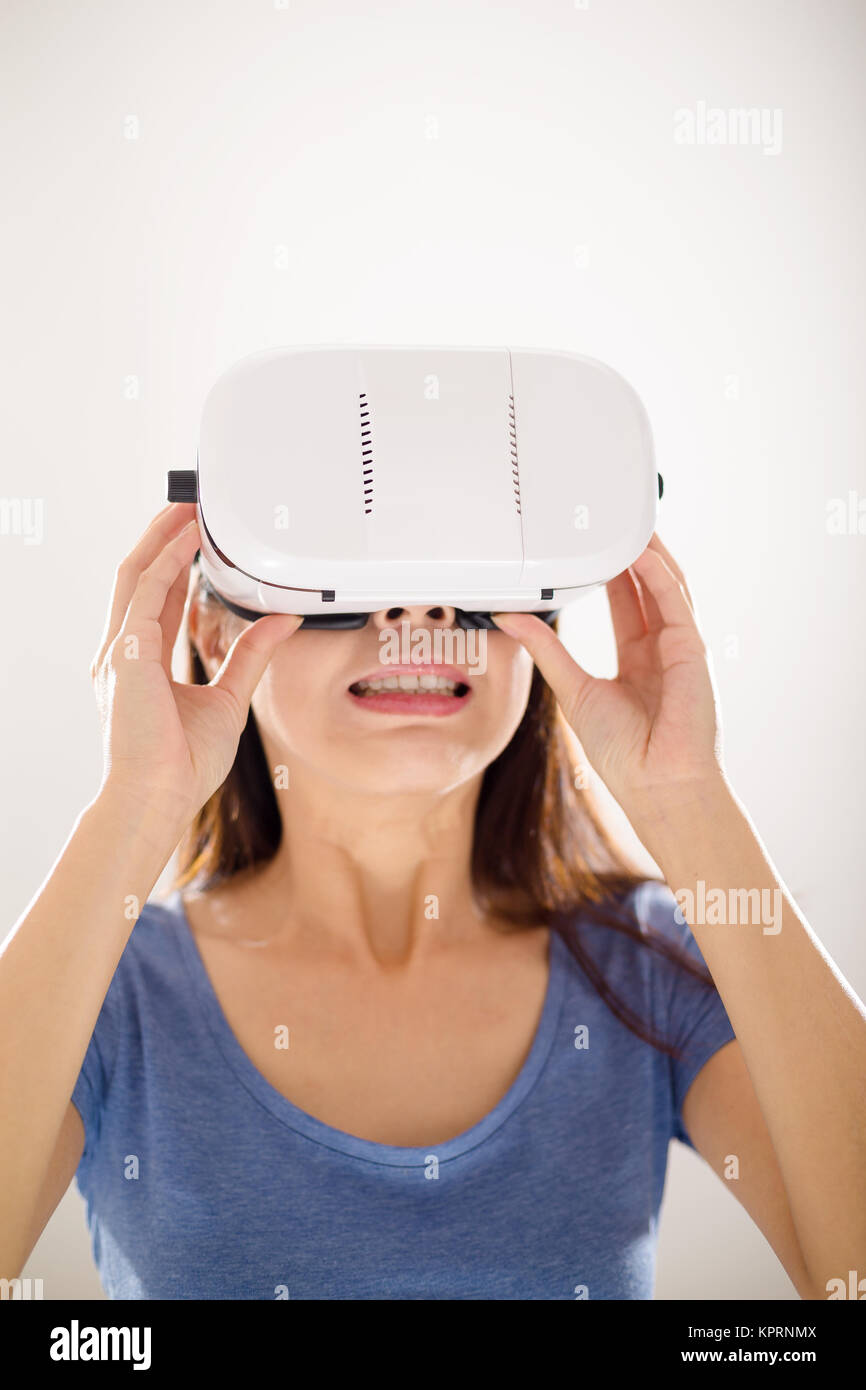 Woman looking though the scary movie with virtual reality Stock Photo