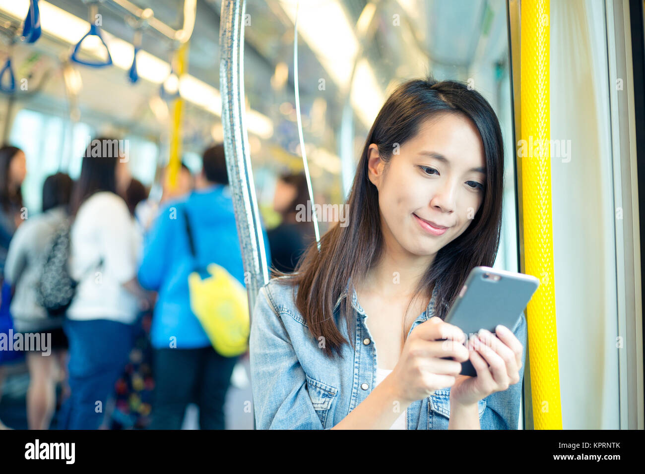 Asian woman use of mobile phone in Hong Kong metro Stock Photo - Alamy