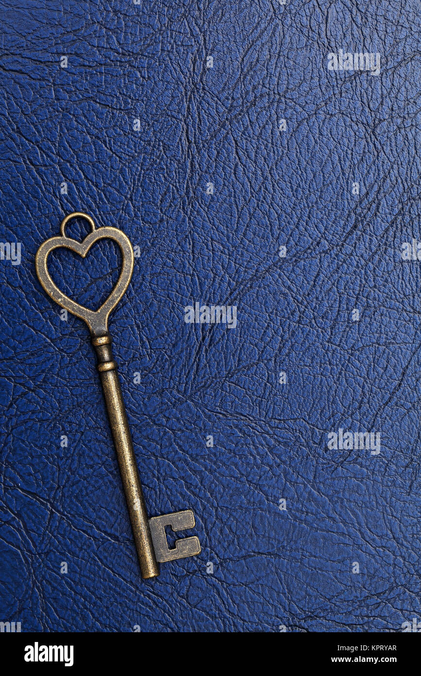 heart shaped vintage key on a blue leather background Stock Photo - Alamy