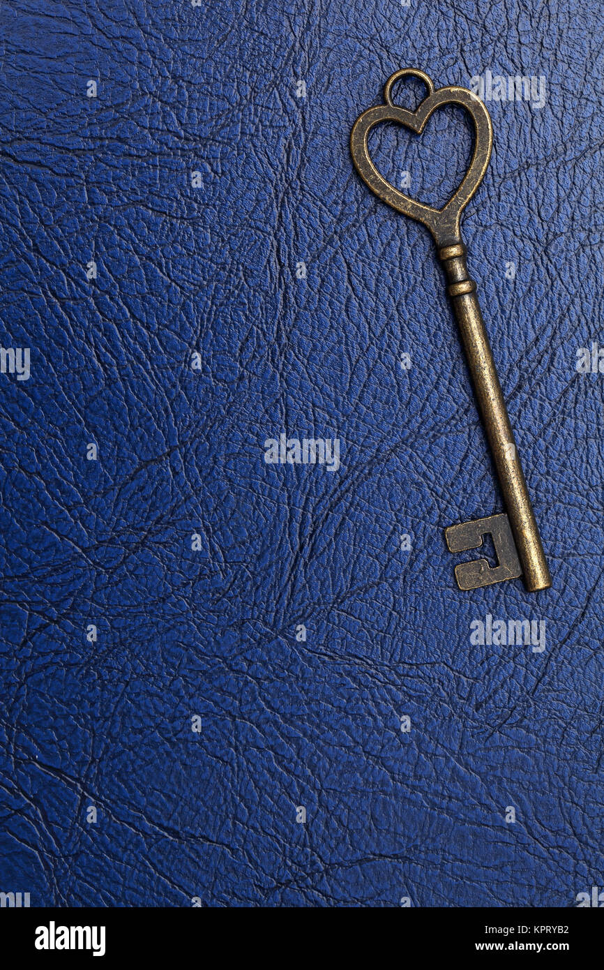 heart shaped vintage key on a blue leather background Stock Photo - Alamy