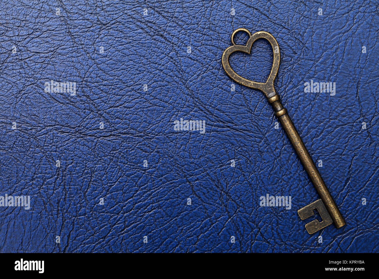 heart shaped vintage key on a blue leather background Stock Photo - Alamy