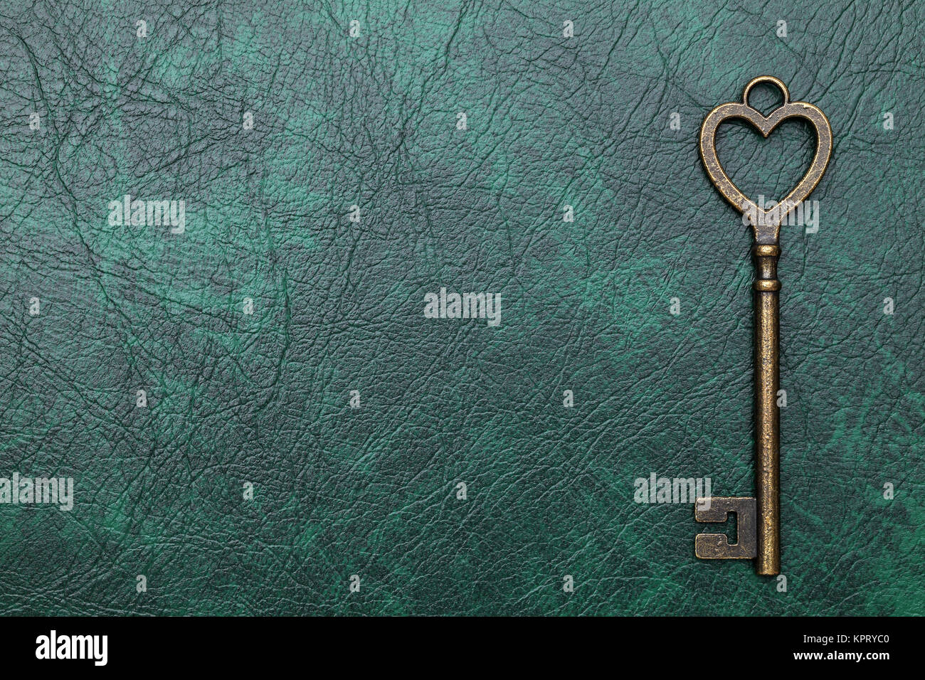 heart shaped vintage key on a leather background Stock Photo - Alamy