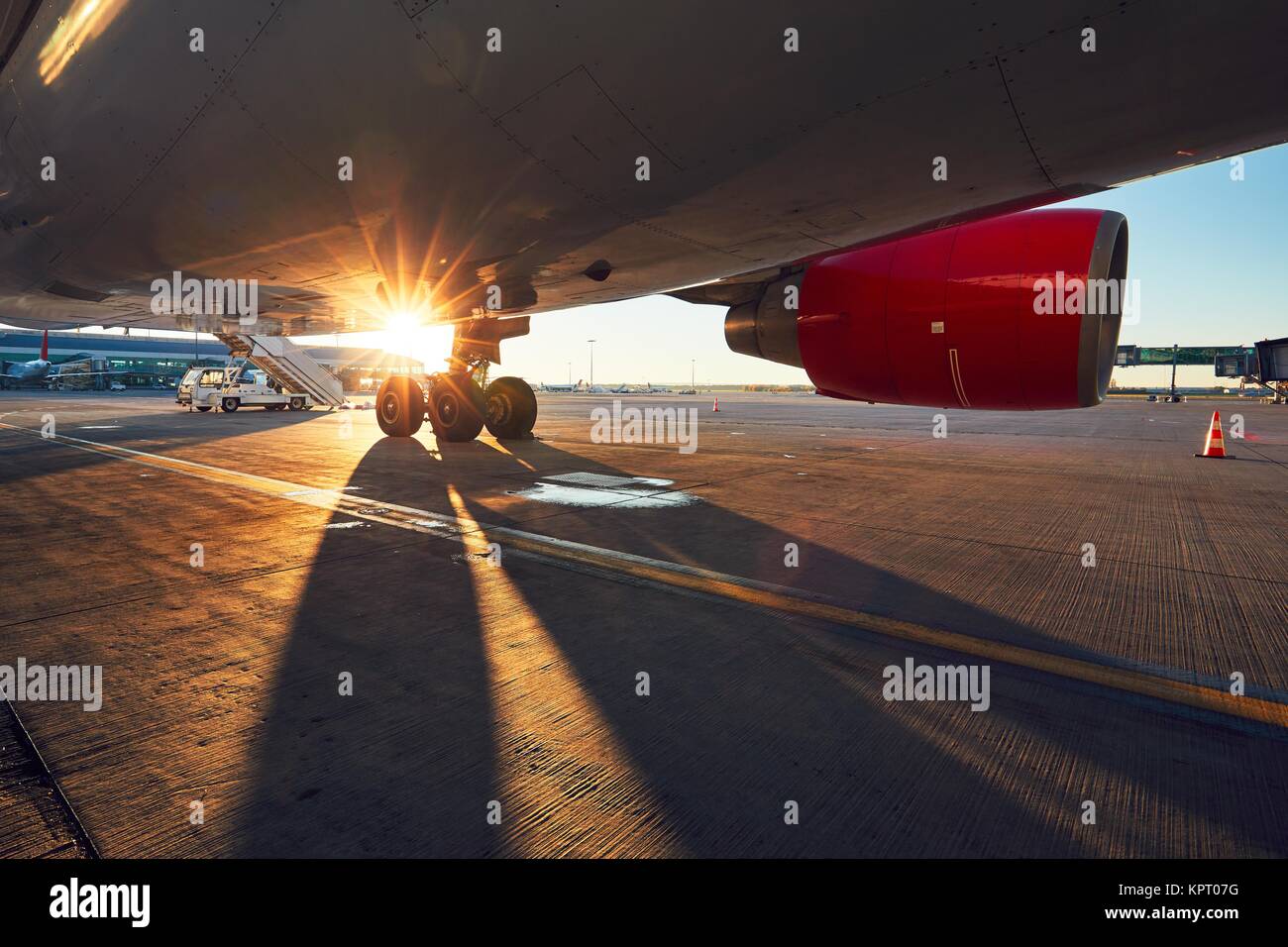 Landing gear of the airplane. Amazing sunset at the airport. Stock Photo