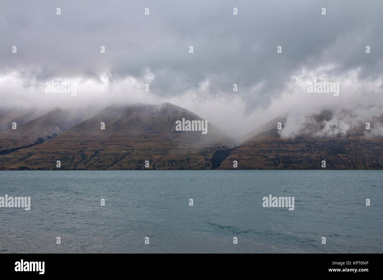 Lake Ohau and Ben Ohau Range on a rainy summer day. South Island, New ...
