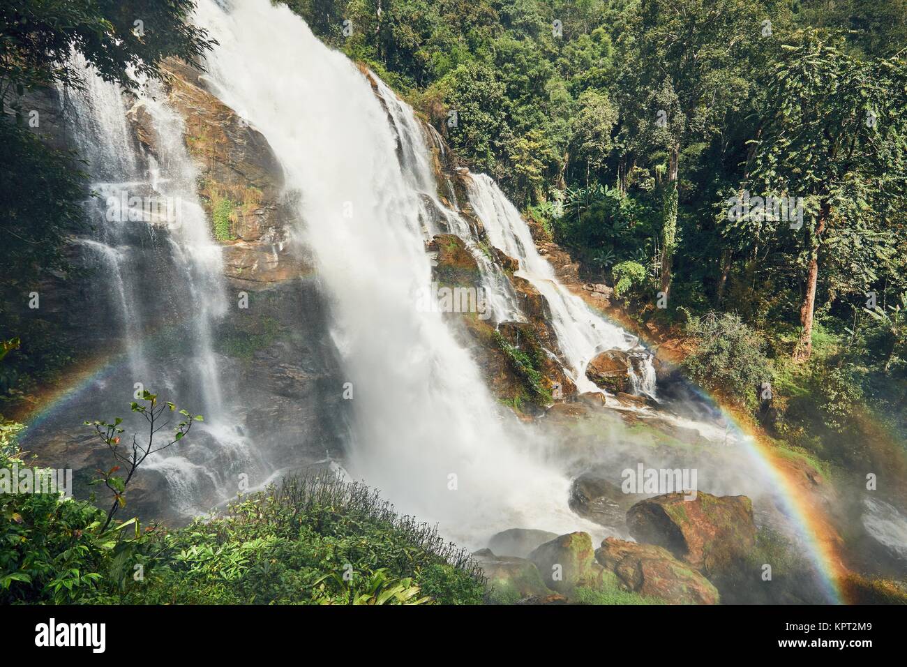 Amazing waterfall with rainbow in tropical rainforest near Chiang Mai, Thailand Stock Photo