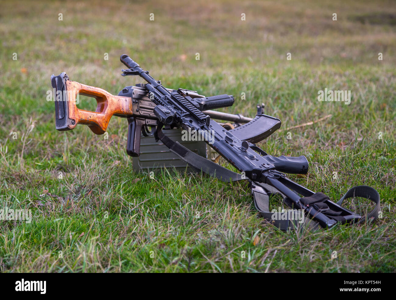 two machine guns lying in the grass Stock Photo