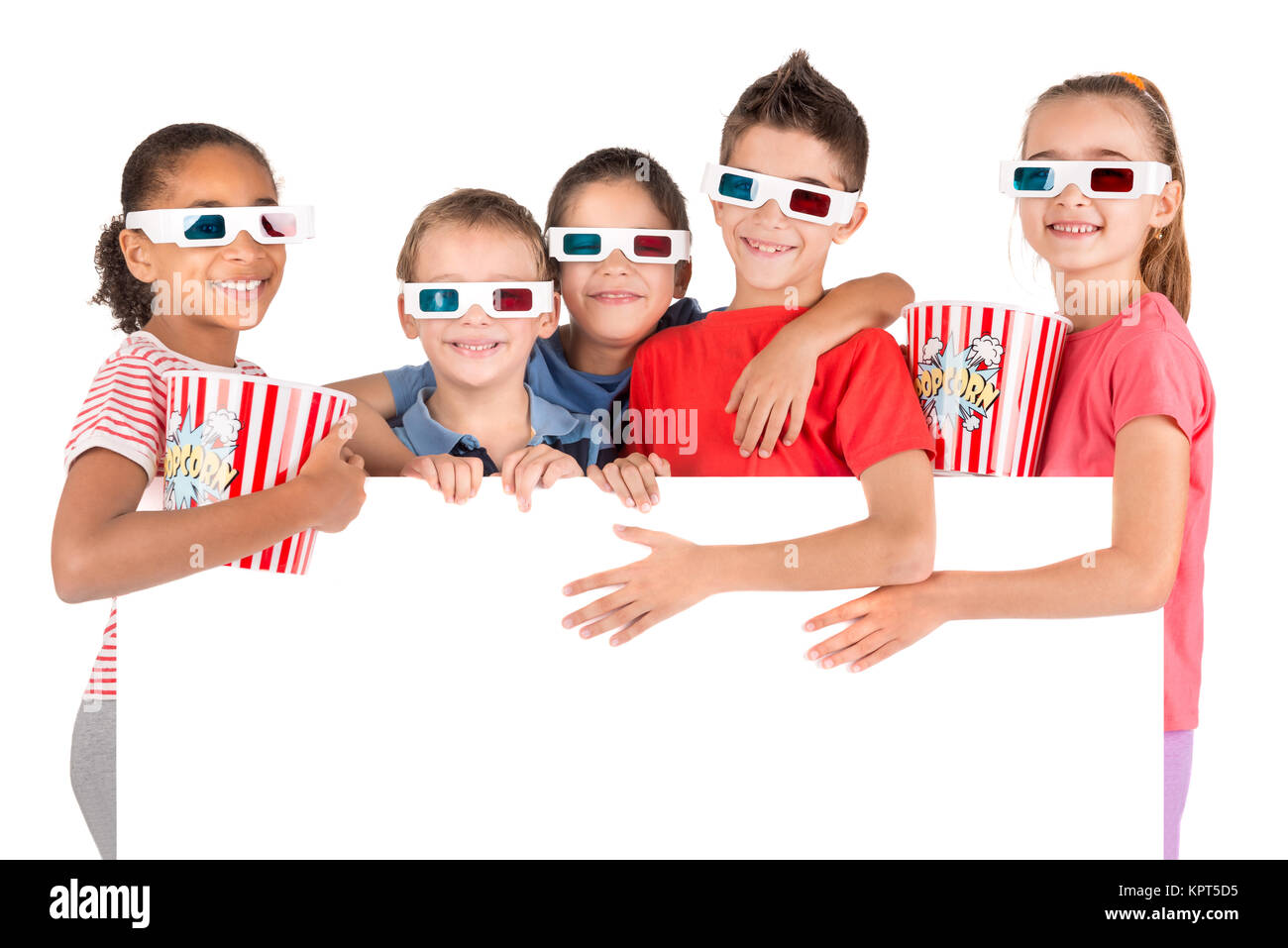 Group of children with 3d glasses and popcorn over a white board Stock Photo