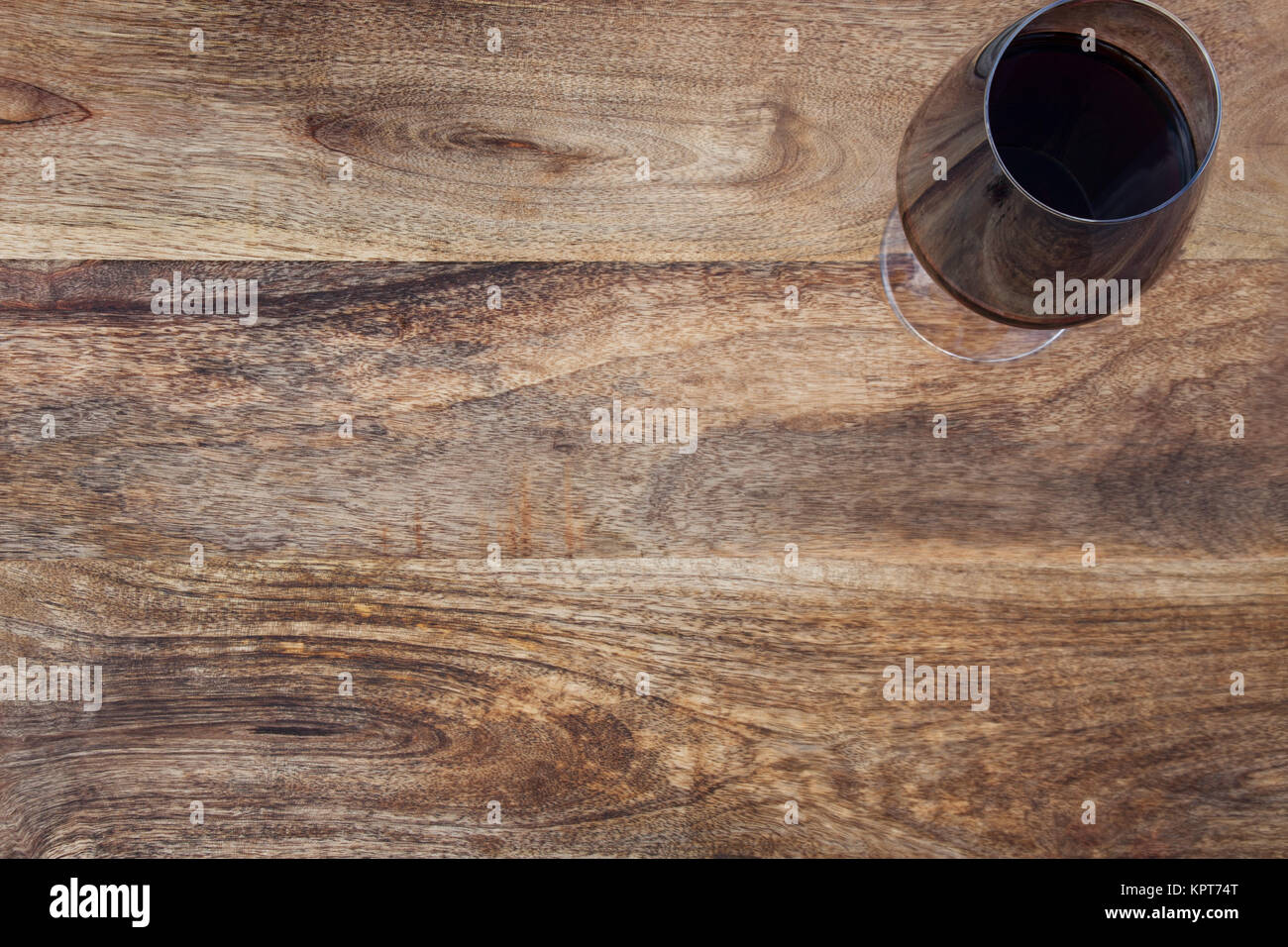 Rustic wooden table with a glass of red wine Stock Photo - Alamy