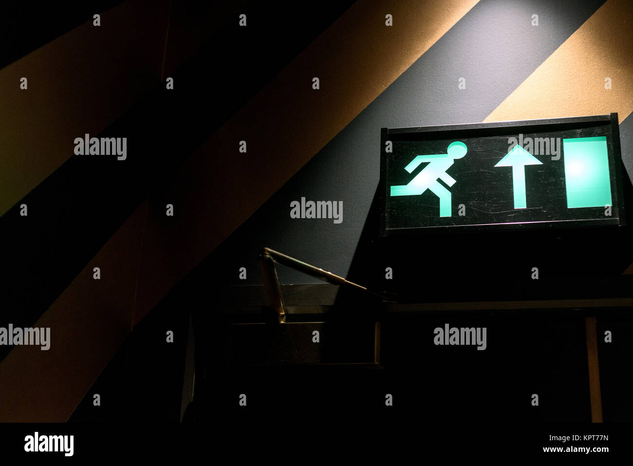 Emergency exit sign in green neon and internal interior light with