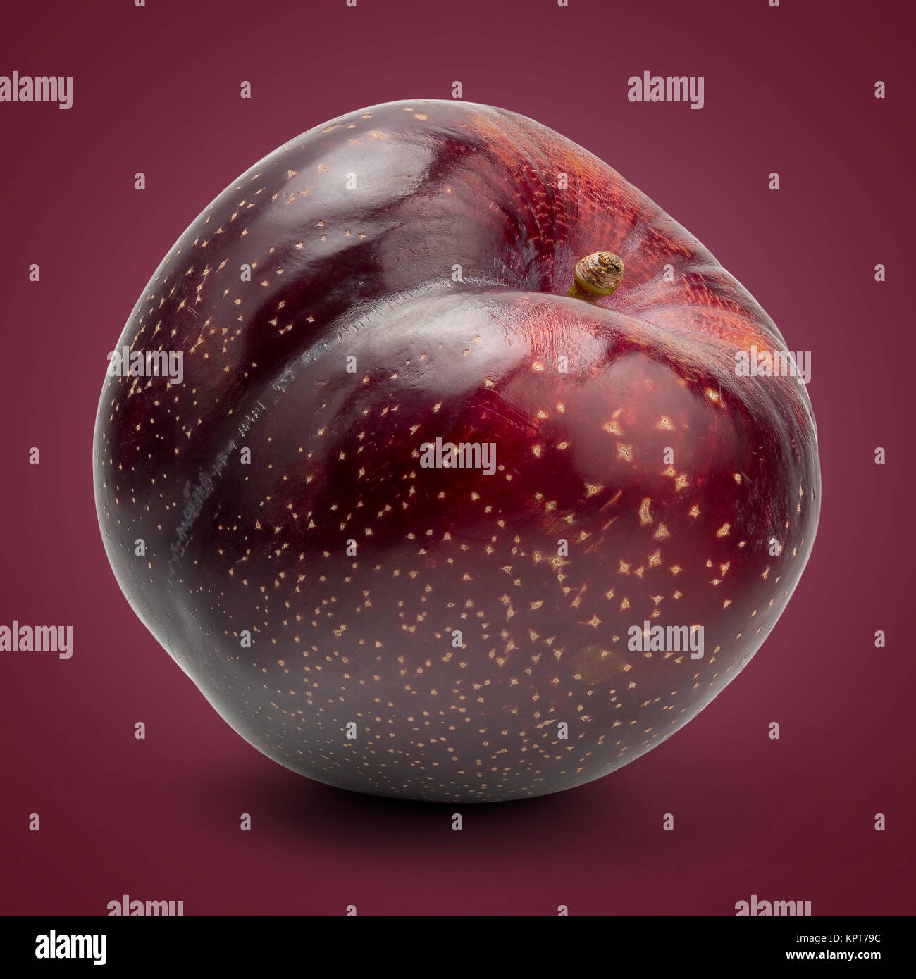 Fresh Red Plum on Red Background Stock Photo - Alamy
