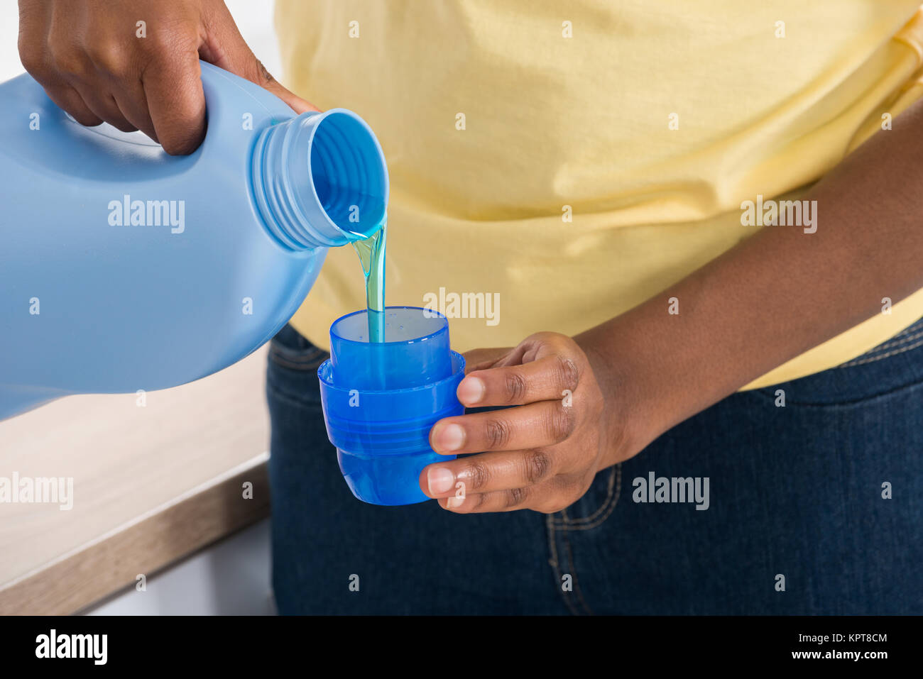 Female Hands Pouring Detergent In The Blue Bottle Cap Stock Photo Alamy