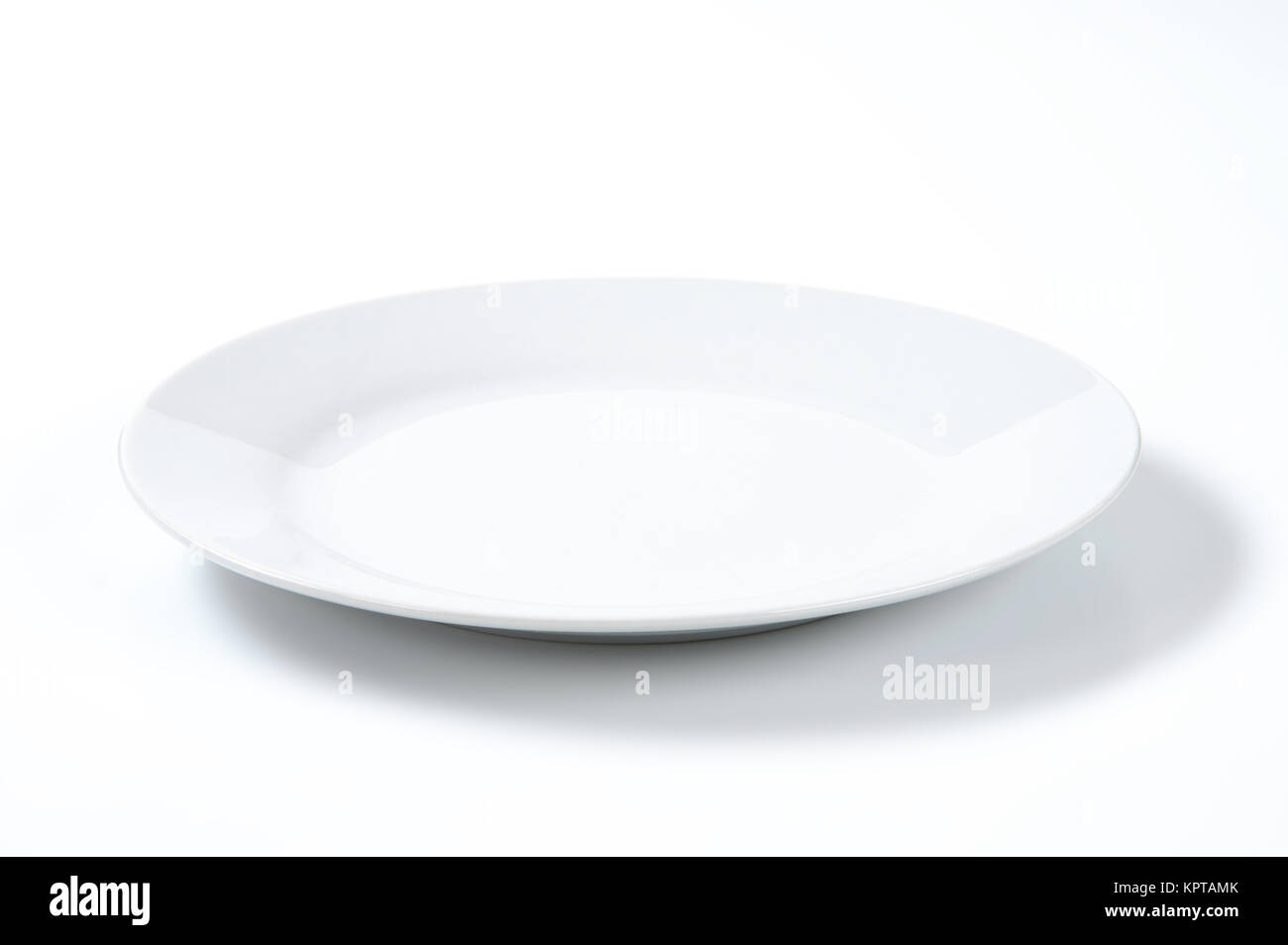 empty white plate on off-white background Stock Photo - Alamy