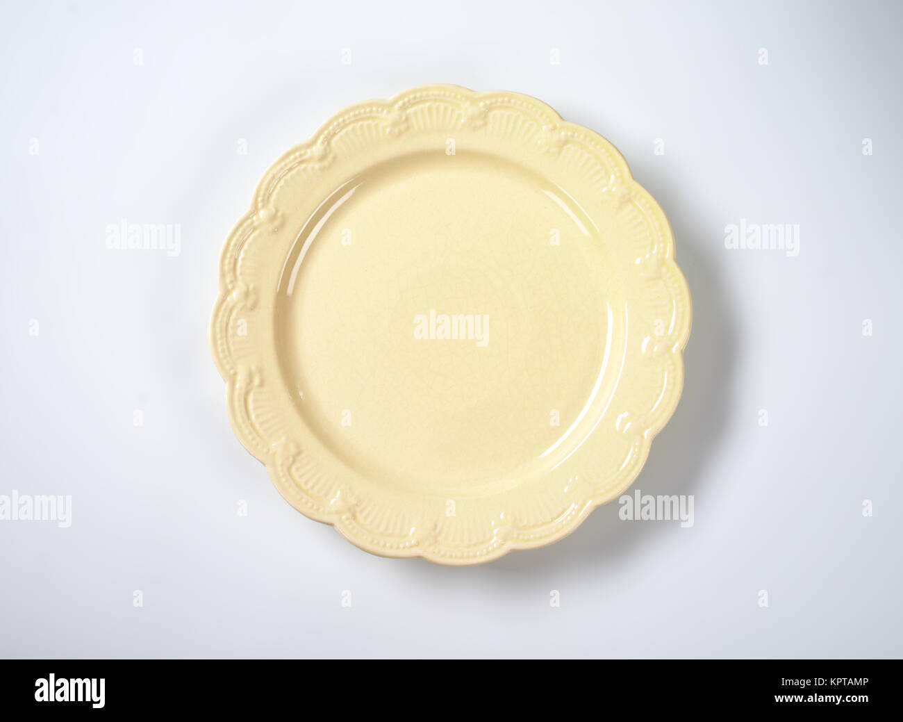 beige plate with embossed rim Stock Photo