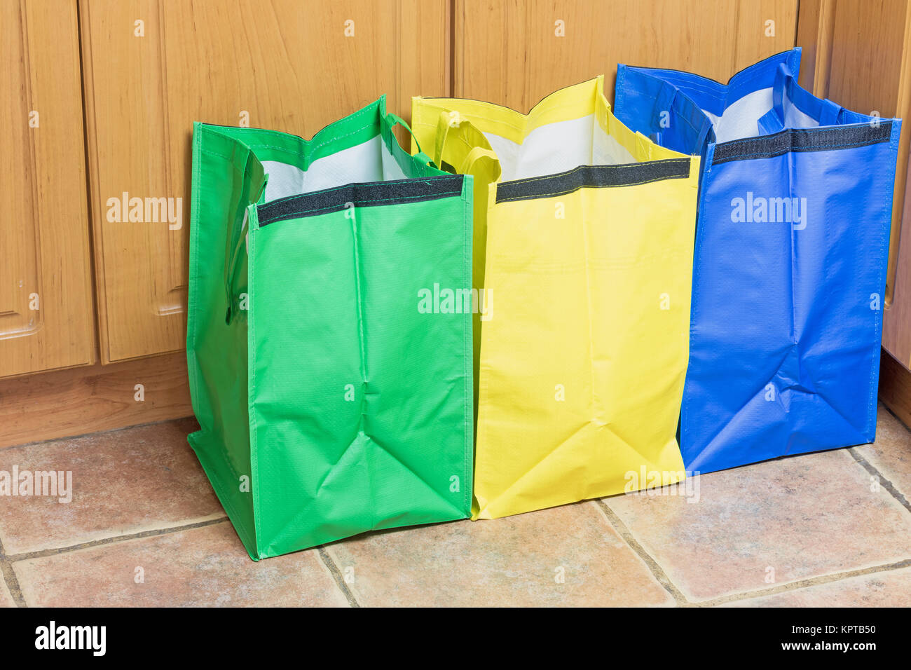 Green, blue and yellow bags are ready to use in sorting household waste Stock Photo Alamy
