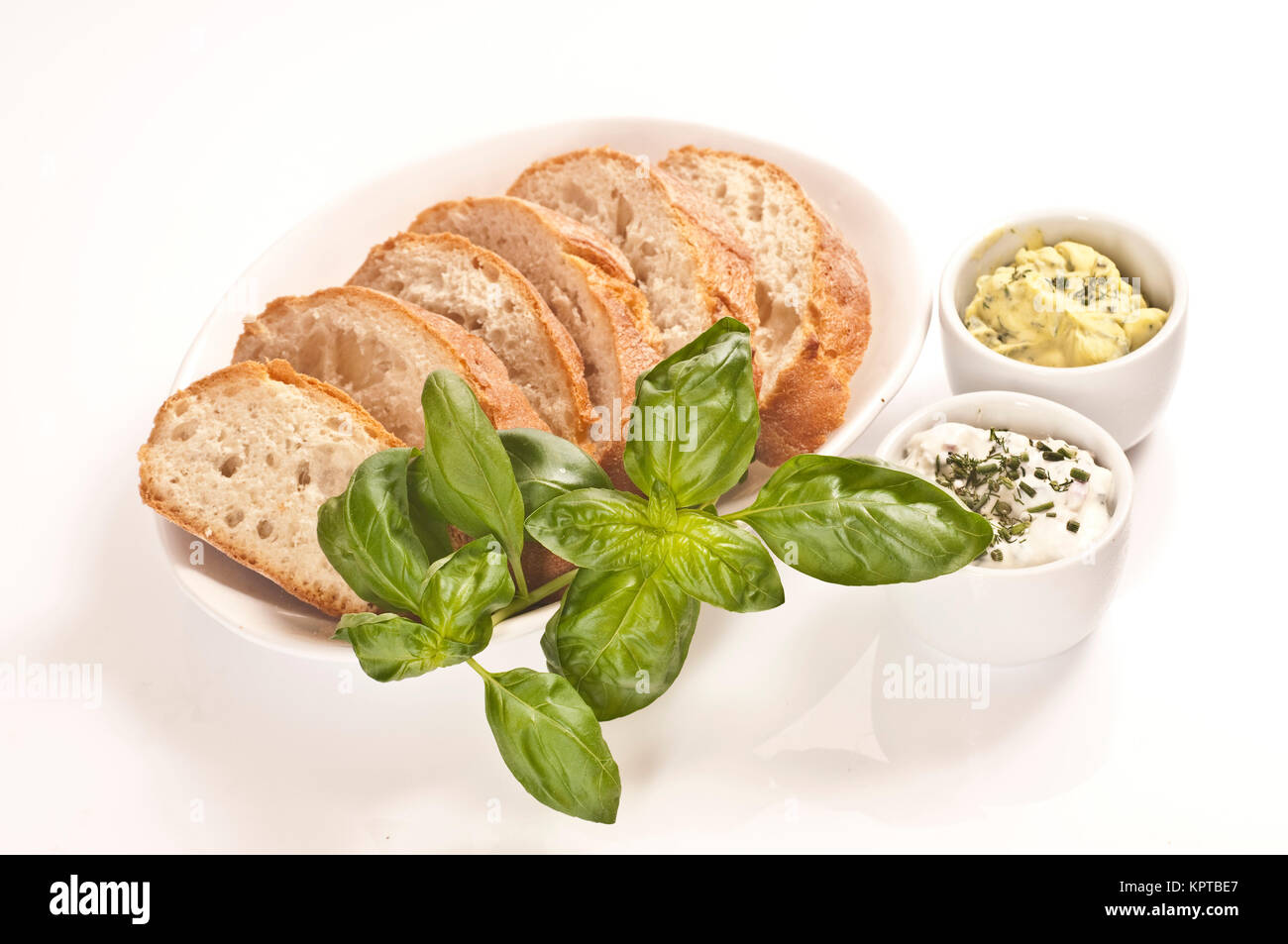 Fresh bread with herb butter and herb quark Stock Photo