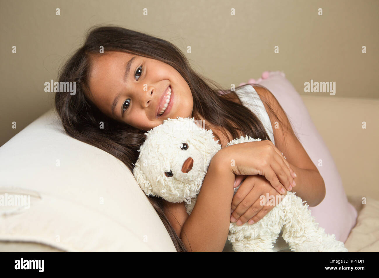 Cute little girl hugging her bear. Stock Photo
