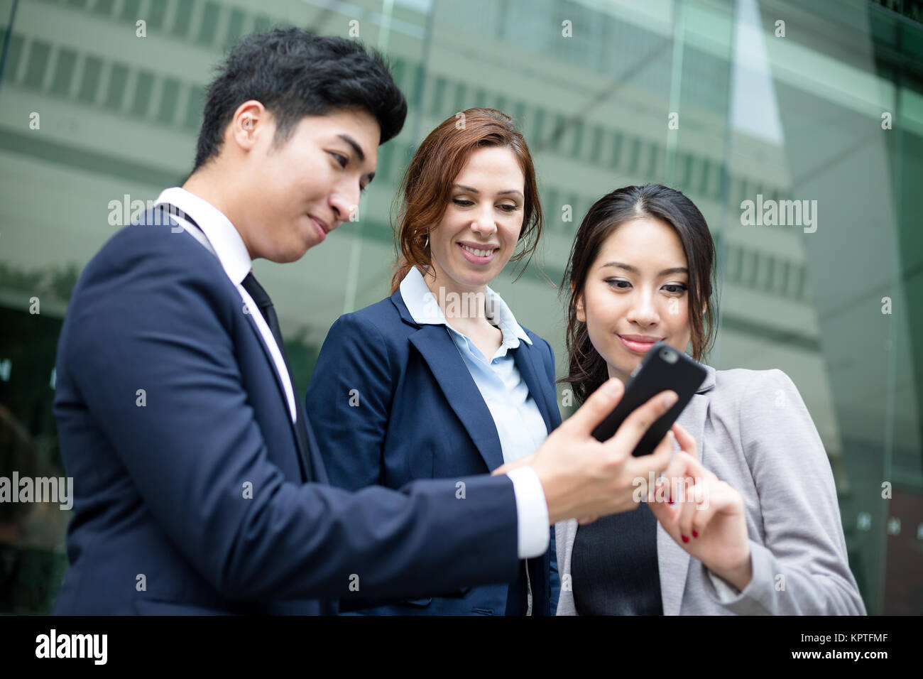Business people discuss on cellphone Stock Photo