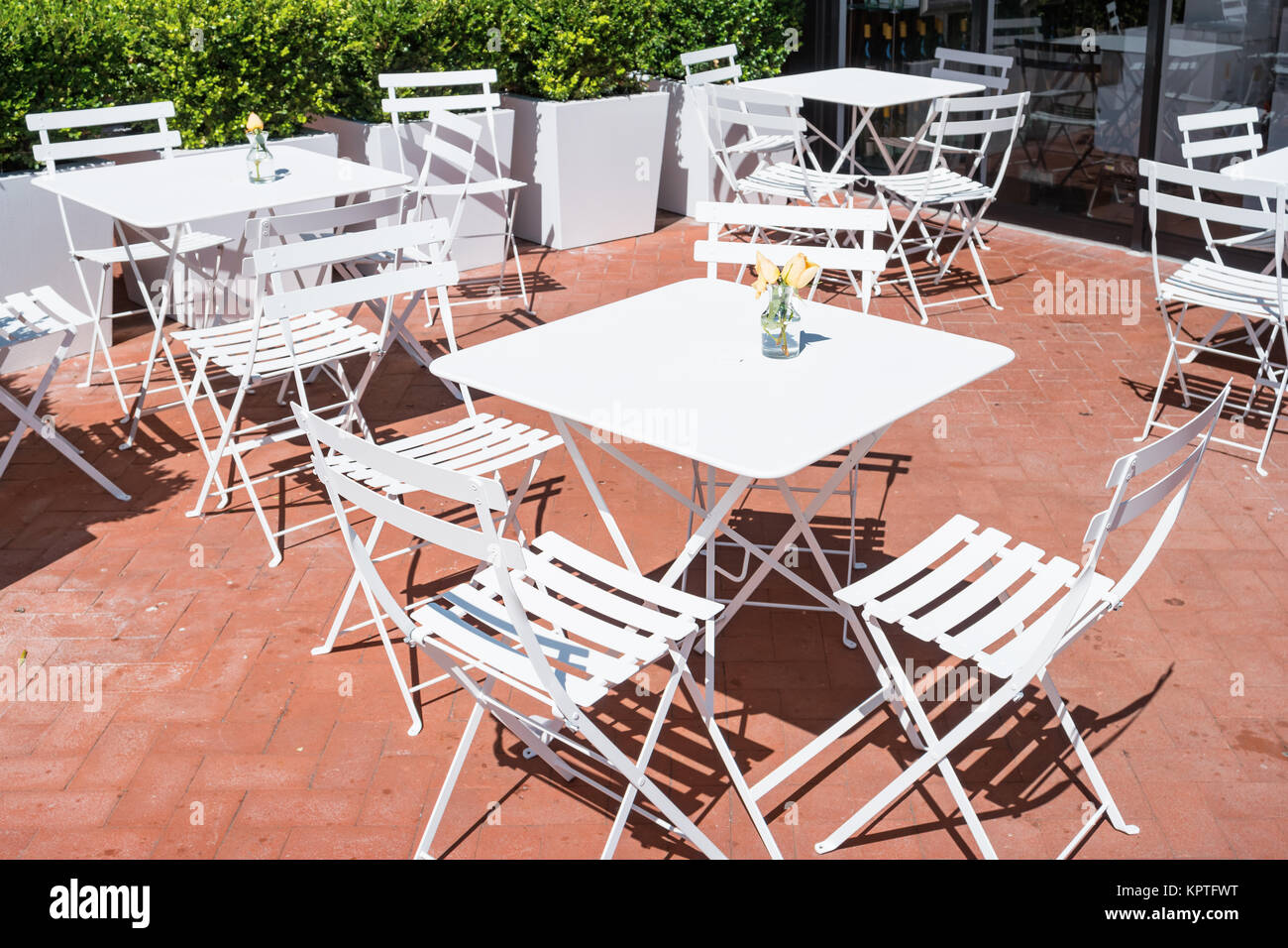 Cafe Restaurant patio with white chairs and tables in  San Francisco, California, USA on a sunny day. Stock Photo