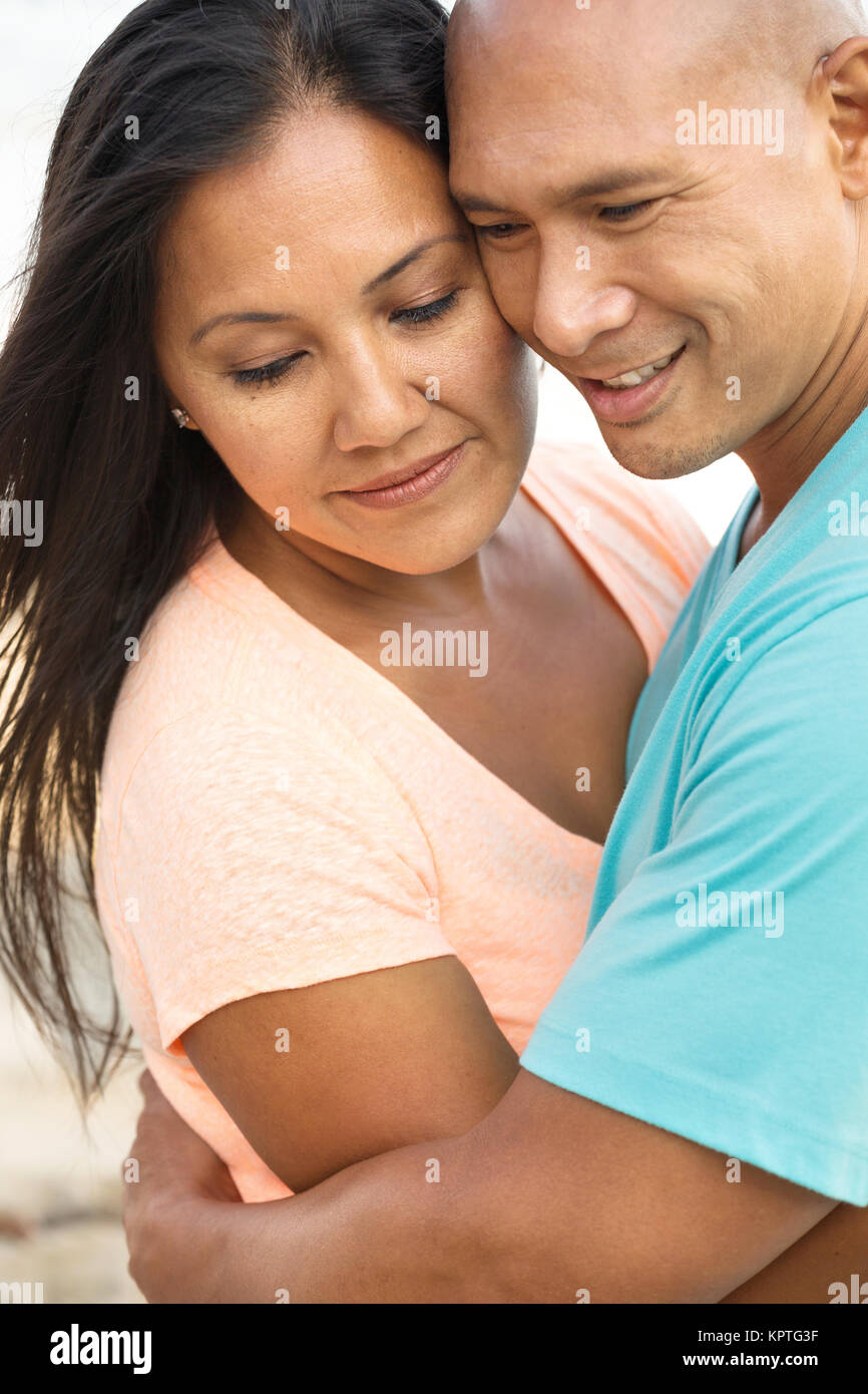 Couple on the beach smiling. Stock Photo