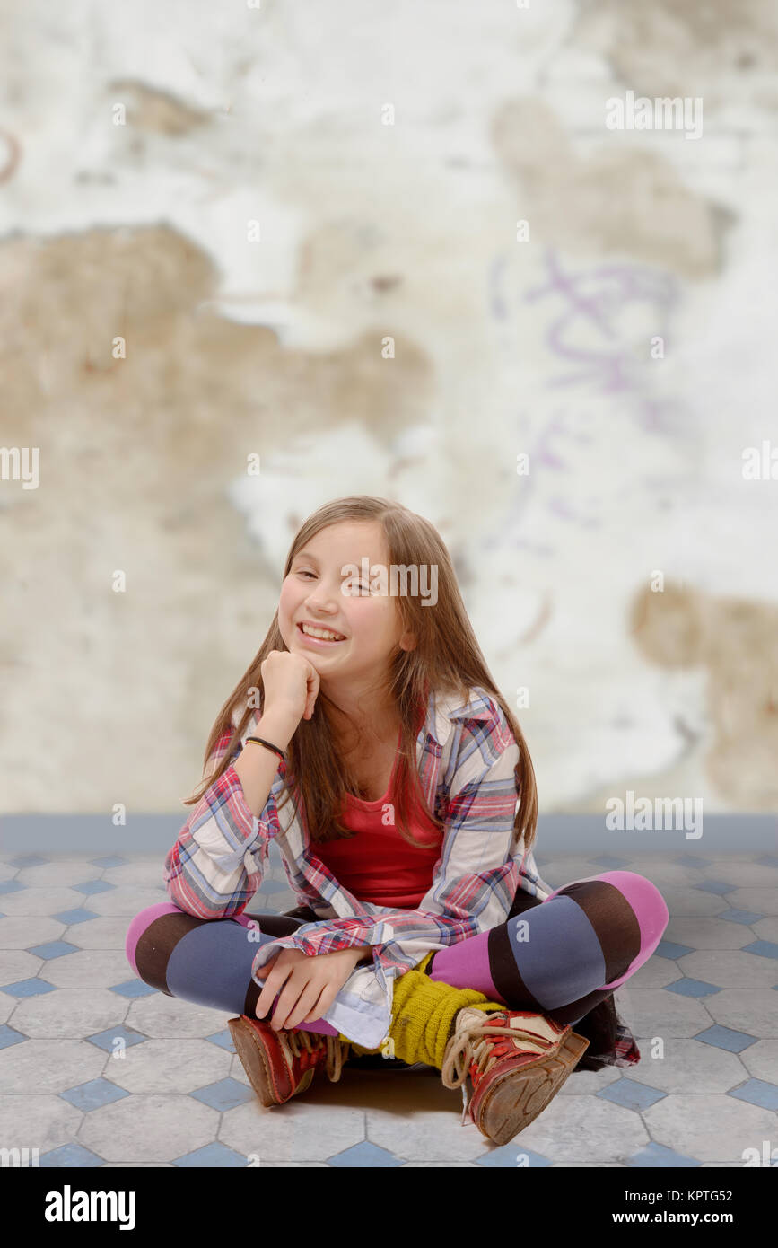 young teenager sitting cross-legged on the floor Stock Photo - Alamy