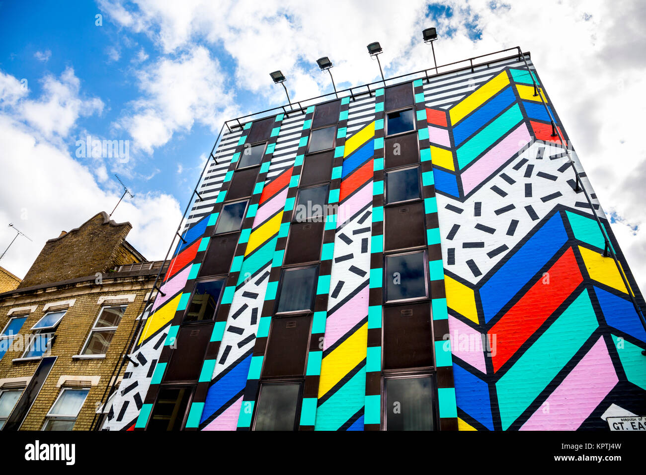 Colourful building painted with graphic zig-zag patterns by artist Camille Walala entitled 'Dream Come True', Great Eastern Street, London, UK Stock Photo