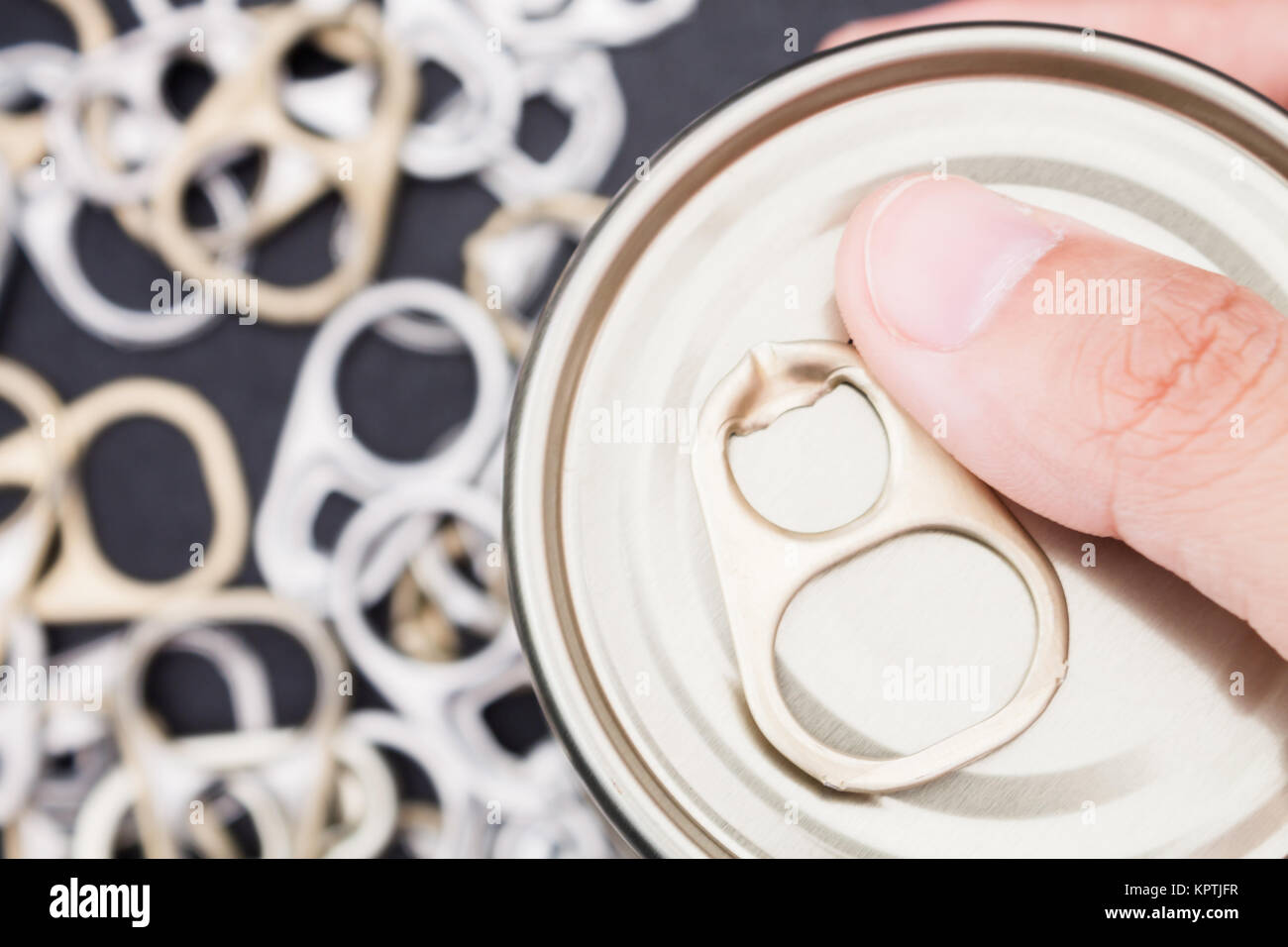 Woman hand holding ring pull cans opener background Stock Photo