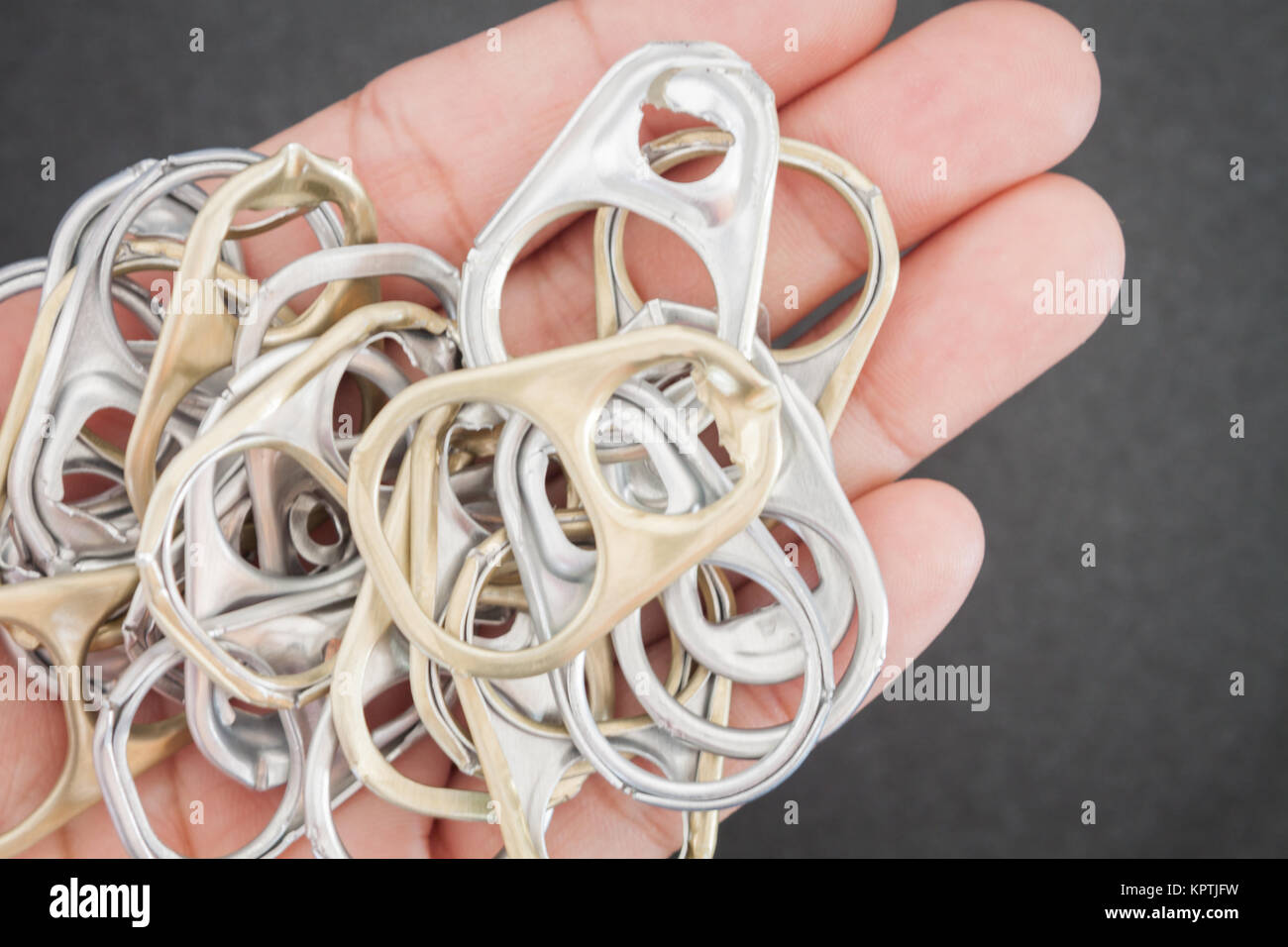 Woman hand holding ring pull cans opener background Stock Photo Alamy