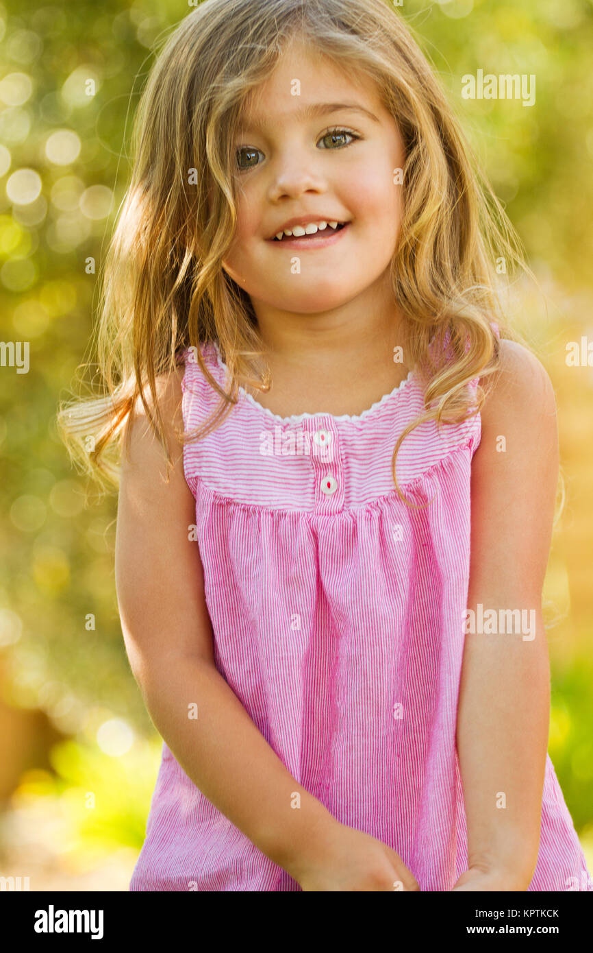 Cute little girl outside smiling Stock Photo - Alamy