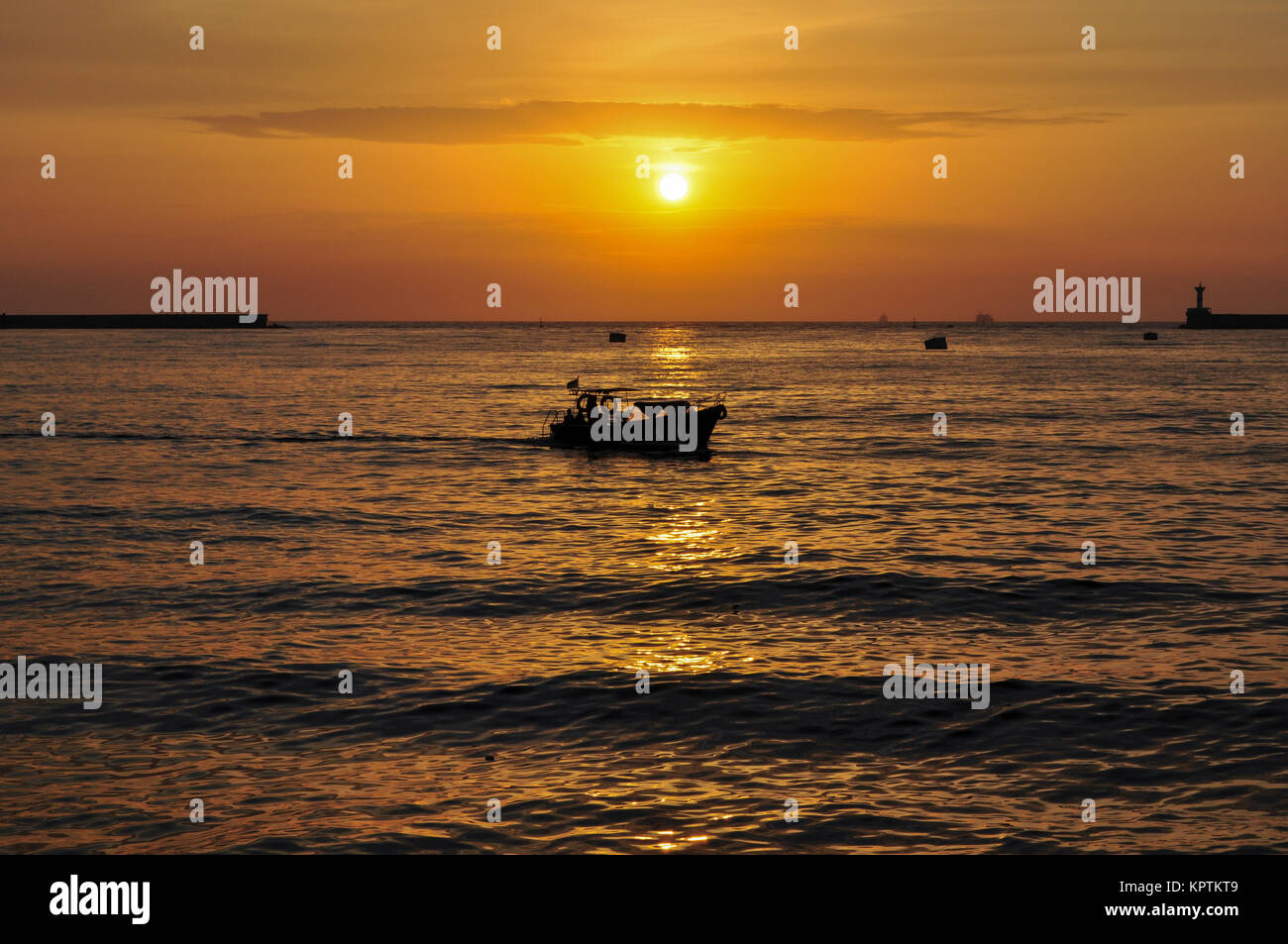 Silhouette of boats at sunset background Stock Photo - Alamy