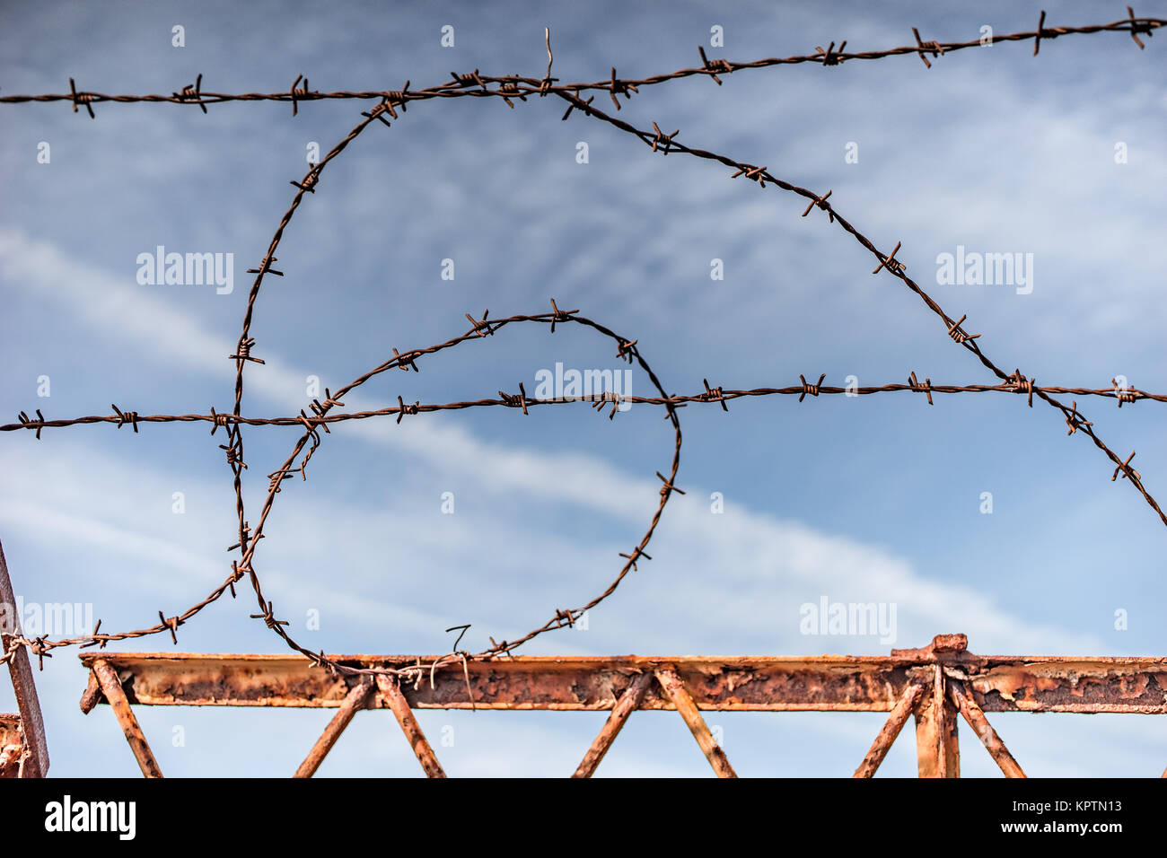 old barbed wire fence on the beach in front of blue water Stock Photo ...