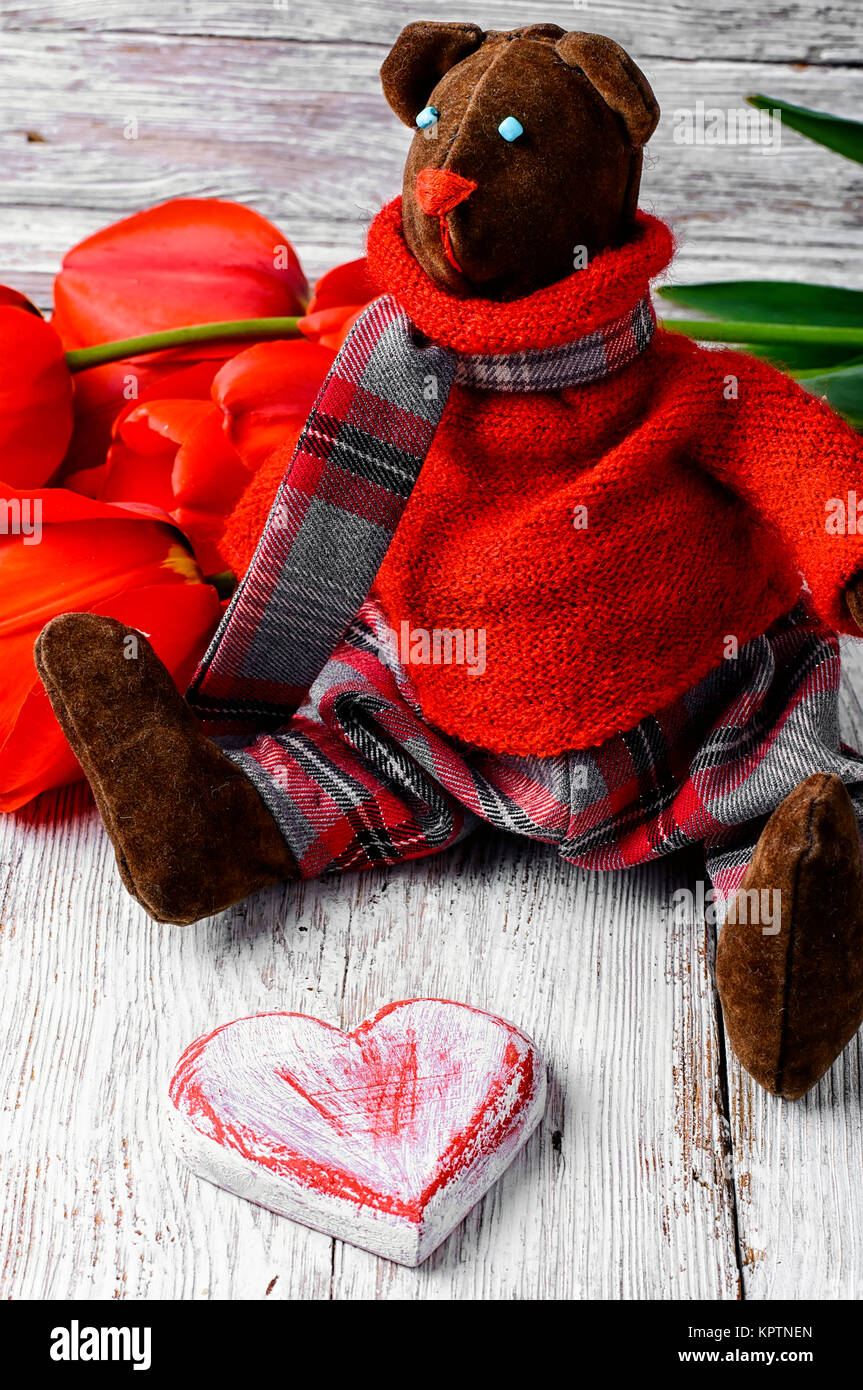 Symbolic soft toy bear and a wooden heart Stock Photo Alamy